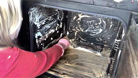 Baking soda paste foaming up as it breaks down grease inside the oven